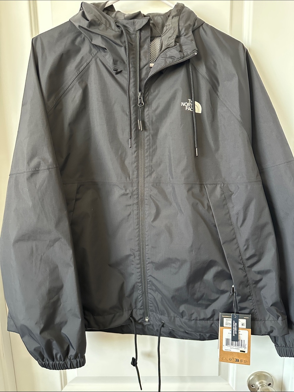 The North Face woman’s Charcoal Hooded Windbreaker Rain Jacket
